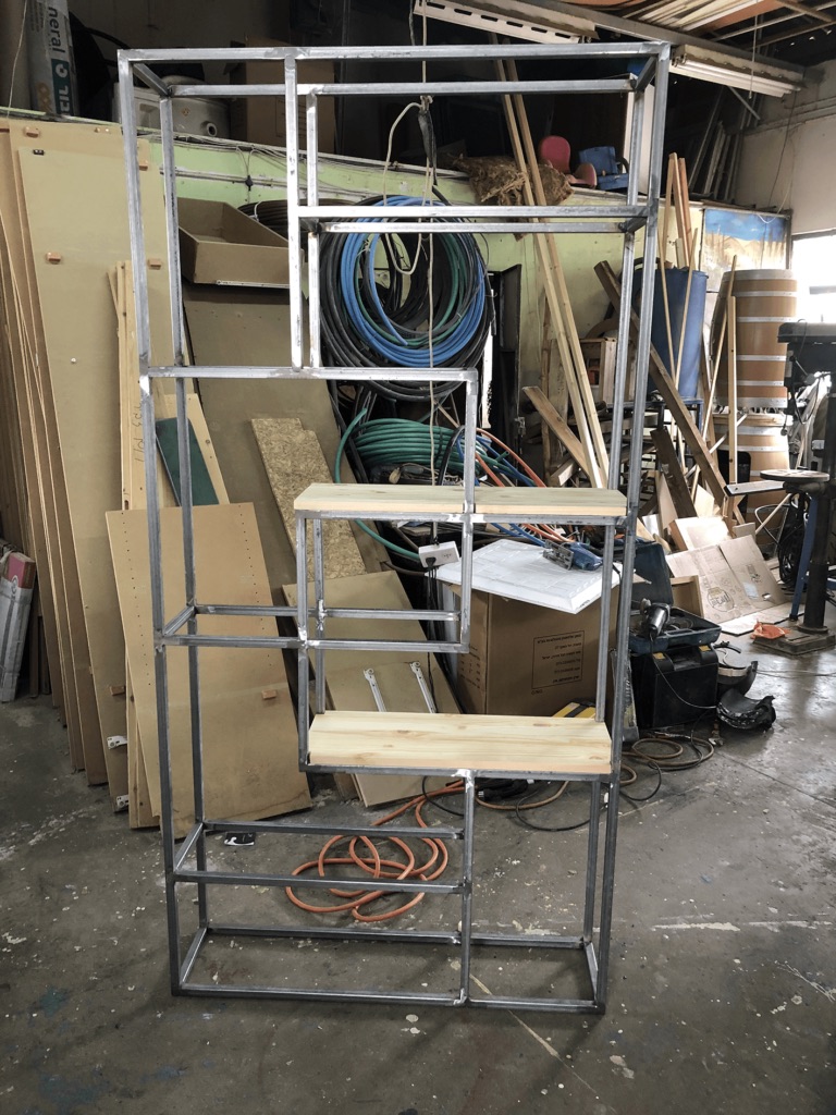 A steel and wood shelf frame in progress