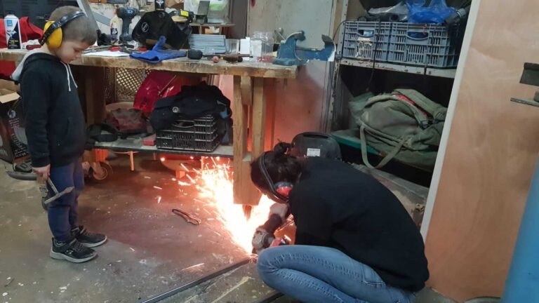 Grinding metal with a child watching
